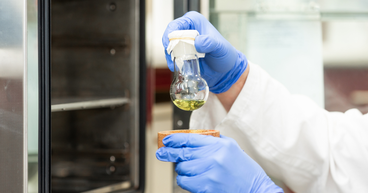 A women conducting an experiment with a vacuum oven.