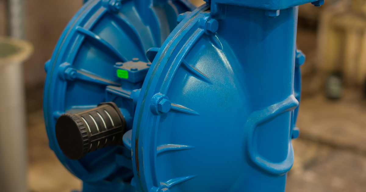 A blue diaphragm pump in an industrial setting.