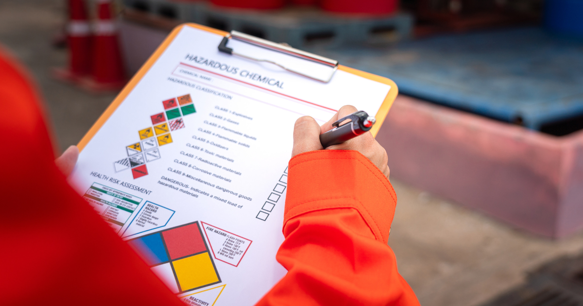 A person conducting an internal hazardous waste audit at their lab.