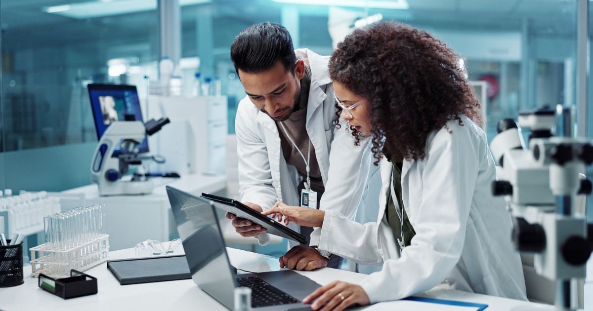 Two scientists discuss an upcoming clinical lab inspection for CAP certification.