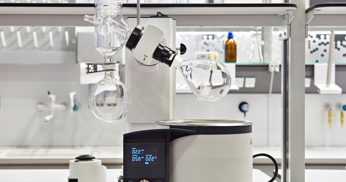 A small rotary evaporator being used in a lab setting.