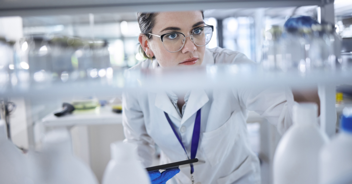 A woman lab tech counting supplies to ready for a lab relocation.