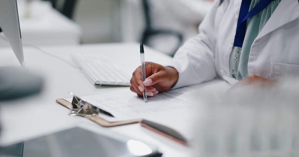 A scientist filling out lab equipment validaiton paperwork.
