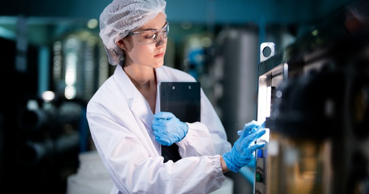 A scientist evaluating lab production equipment.