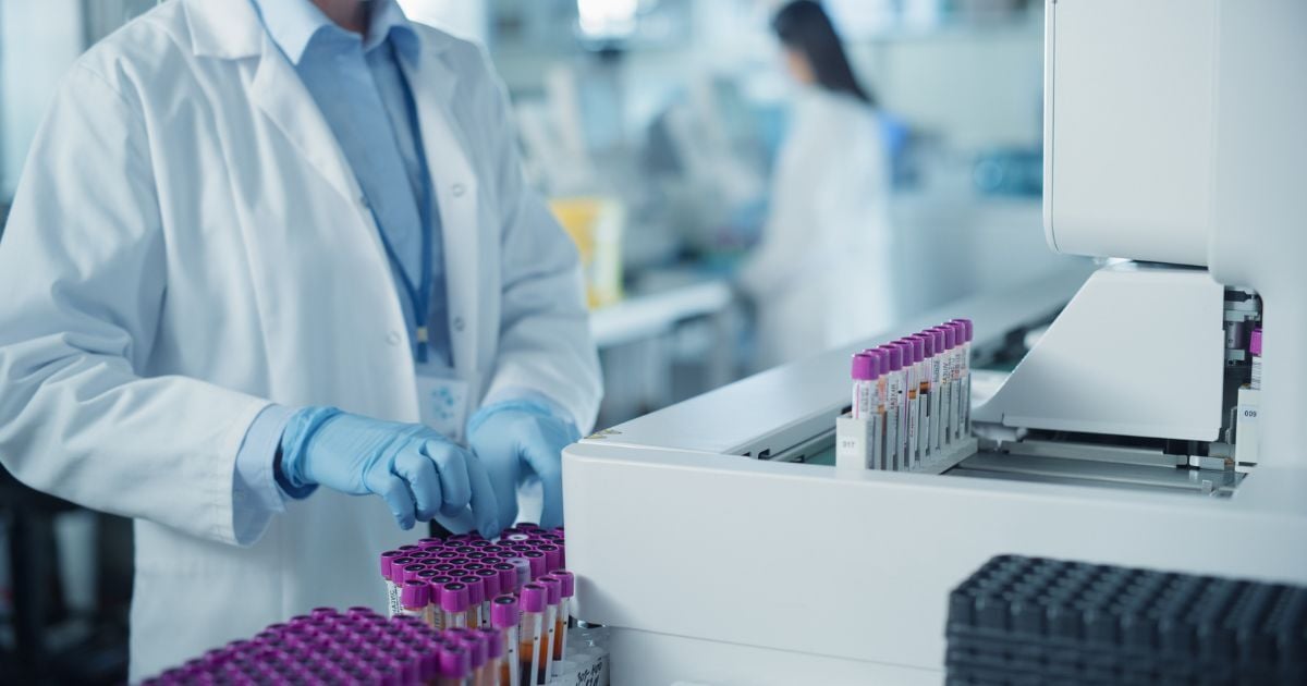 Skilled laboratory technician operating advanced diagnostic equipment.