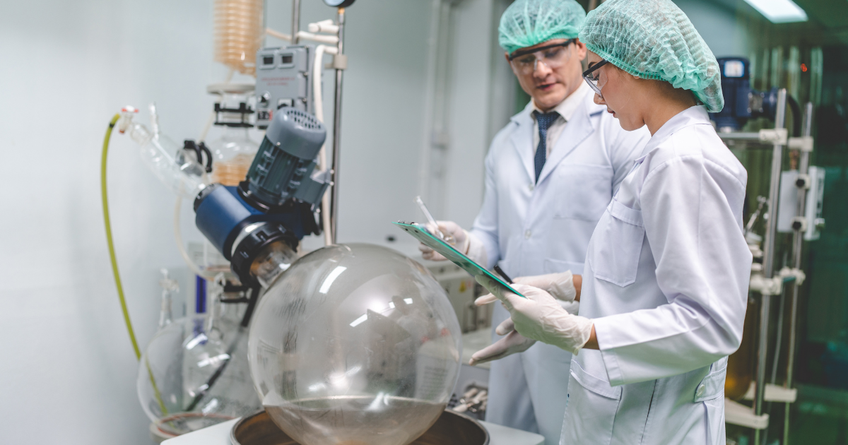 Two scientists discussing the rotary evaporator.