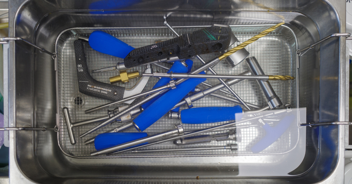 Surgical instruments being cleaned by an ultrasonic cleaner.
