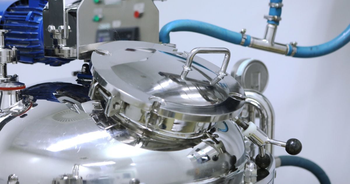 A lab storage vessel with a closed lid and a tube running to it.