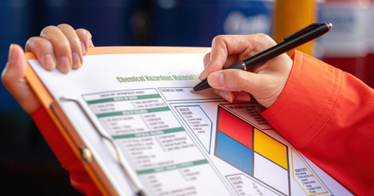 A person conducting a safety check of a lab's specs.