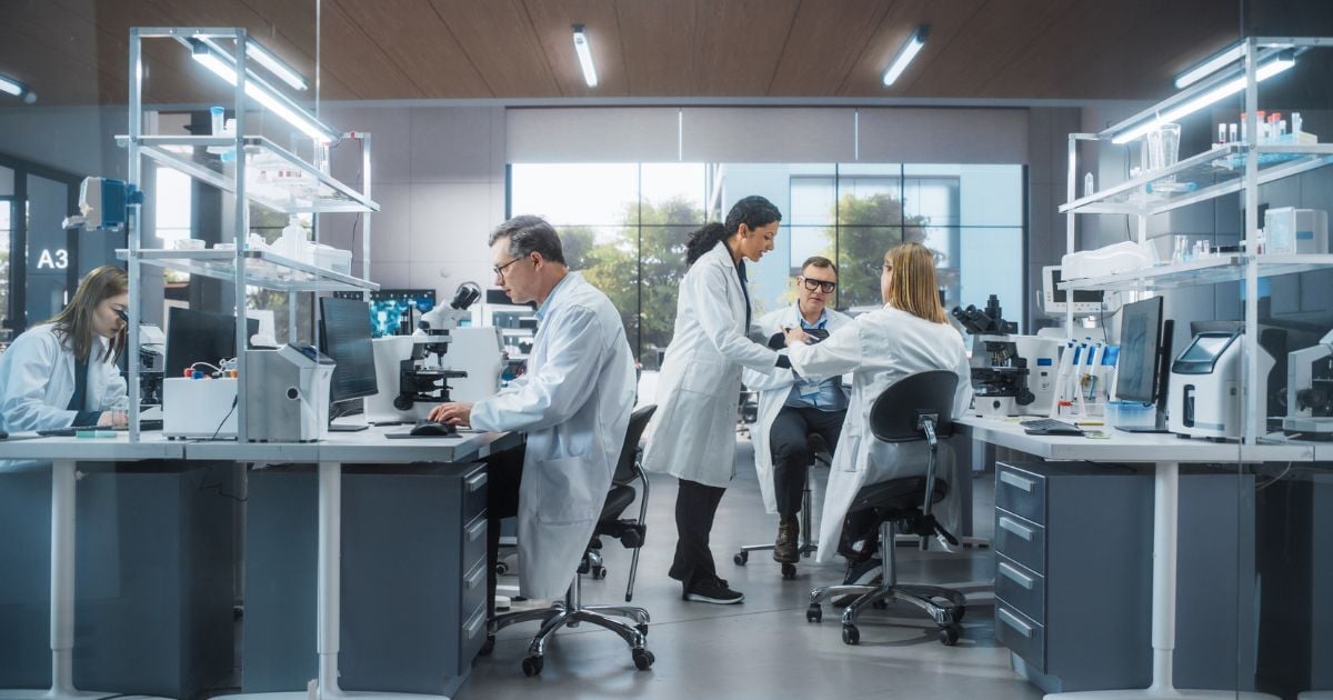 A group of scientists in a lab having a discussion.